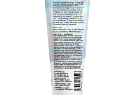 a tube of white cream with a rainbow colored background
