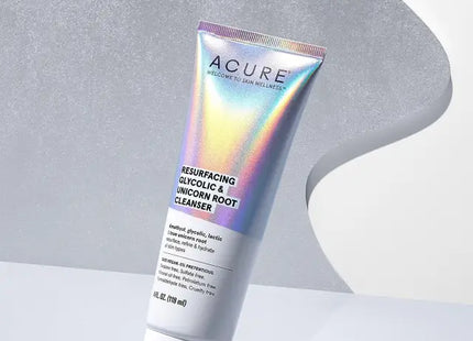 a close up of a tube of acure brightening body lotion on a white surface