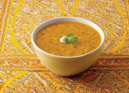 a bowl of soup with a spoon and napkin