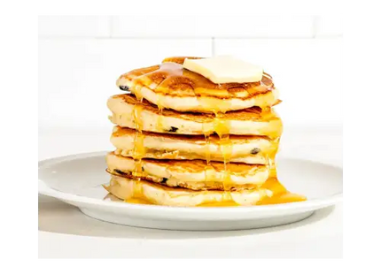 a stack of pancakes with syrup syrup drizing on top