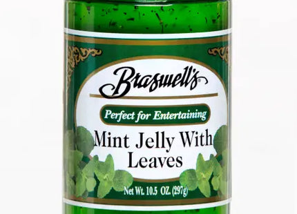 a close up of a jar of mint jelly with leaves