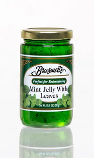 a close up of a jar of mint jelly with leaves