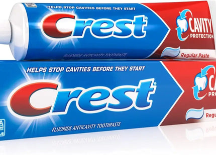 two tubes of crest toothpaste sitting on top of each other