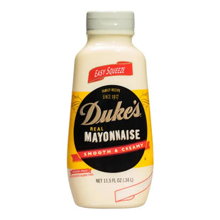 a close up of a bottle of mayonnaise on a white background