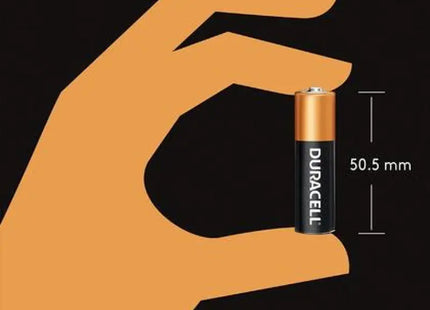 a hand holding a battery with the size of the battery