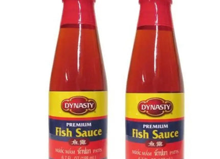 two bottles of fish sauce on a white background