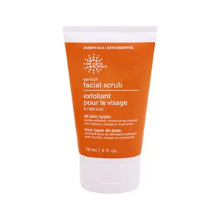 a tube of facial scrub with orange and white background