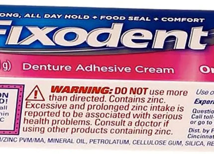 a close up of a box of fixdent cream on a white background