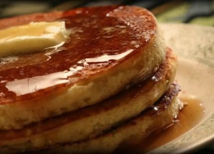 a plate with pancakes and syrup on it