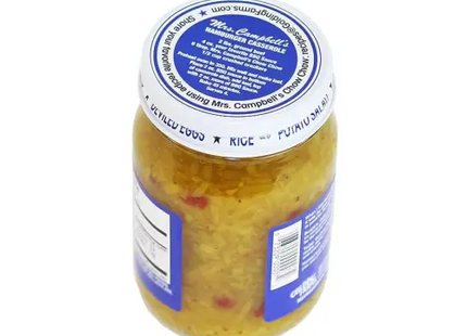 a close up of a jar of pickled vegetables on a white surface