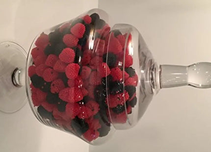 a glass vase filled with berries and blackberries