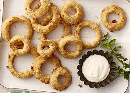 a plate of onion rings with ranch sauce