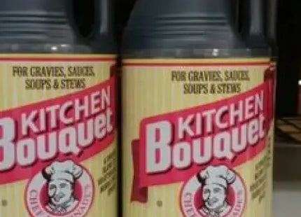 two bottles of brown liquid sitting on a counter