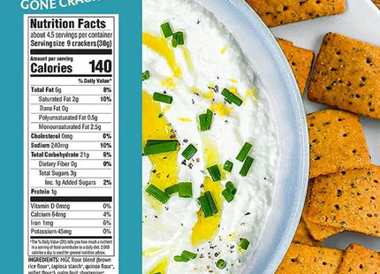 a close up of a bowl of dip with crackers on a plate