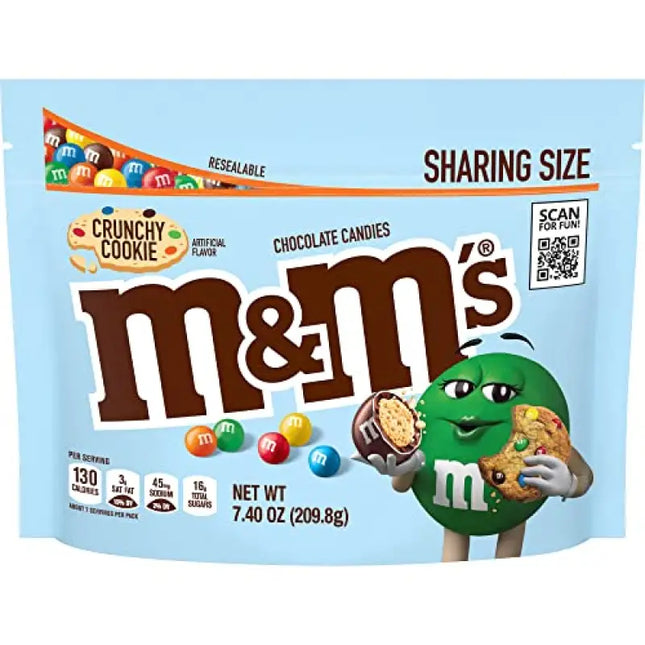 a close up of a bag of m & m’s with a cookie on top