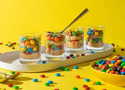 a plate with three glasses filled with candy