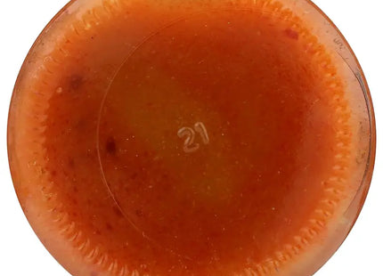 a close up of a glass bowl filled with a mixture of orange liquid