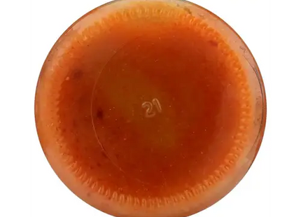 a close up of a glass bowl filled with a mixture of orange liquid