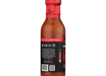 a close up of a bottle of hot sauce on a white background