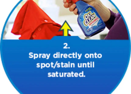 a person cleaning a red shirt with a spray