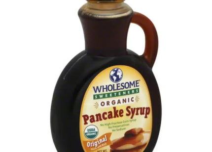 a close up of a bottle of syrup with a spoon